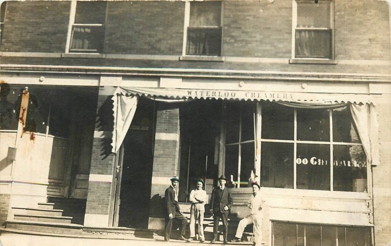 Postcard RPPC C-1910 Iowa Waterloo Creamery Street 4 men hats 23-13613