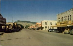 Cody WY Street Scene Cars Stores Postcard