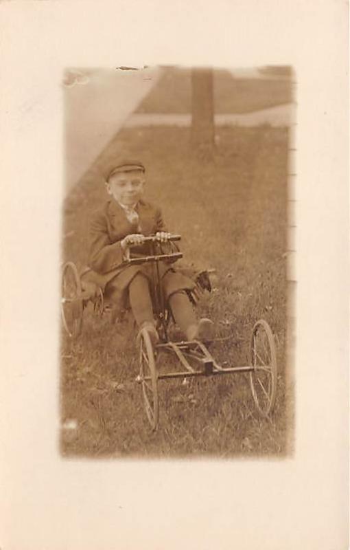 Child on toy car Irish Male Child, People Photo Writing on back 