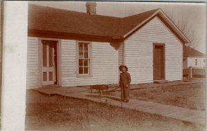 Young Boy with Wagon Woodne Sidewalks Woman Peeking out Door Postcard U3