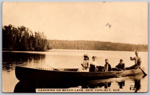 RPPC c1915 New Carlisle Quebec Canoeing On Beach Lake Split Ring Paspébiac West