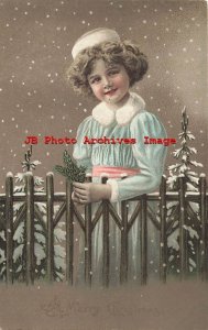 Christmas, H & S B, Girl Wearing Robe outside in the Snow Standing by Fence