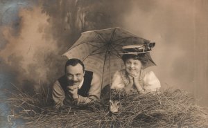 Vintage Postcard Lovers Couple Photoshoot Laying Under The Umbrella Romance