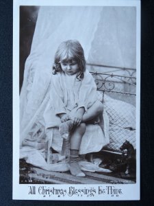 A Christmas Blessing be Thine LITTLE GIRL PUTTING ON SOCKS c1908 RP Postcard