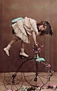 BEAUTIFUL YOUNG GIRL-TRICKS ON TRICYCLE~BONNE ANNEE-NEW YEAR~PHOTO POSTCARD