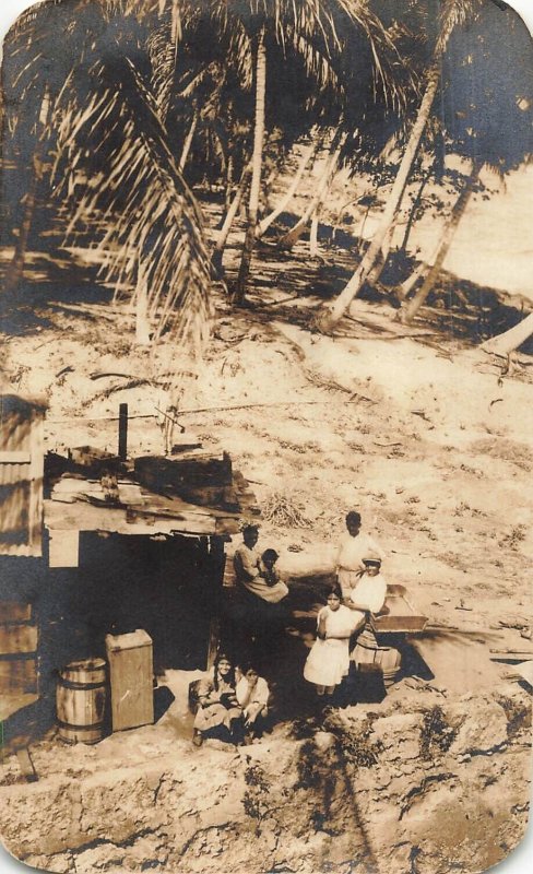 TROPICAL LOCATION-NATIVE FAMILY WITH CHILDREN IN HUT~REAL PHOTO POSTCARD