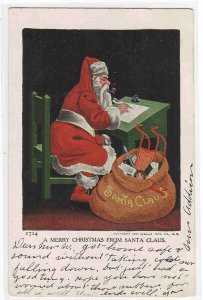 Santa Gift List at Desk Bag of Toys Christmas 1907 postcard