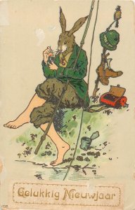 Humanized rabbit fishing and pipe smoking New Year 1920 greetings Netherlands