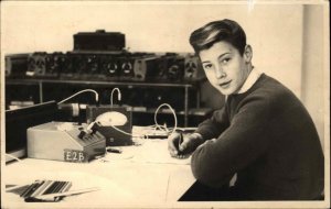 Boy at Desk Writing Radios? Wires Instruments Science Real Photo Postcard