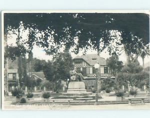 old rppc STATUE BESIDE BUILDING Petropolis Brazil HM1764