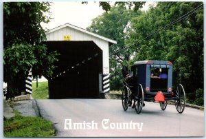 An Amish horse and buggy enters one of the numerous covered bridges - PA