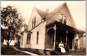 A Woman and Two Men On A Porch Mansion House RPPC Real Photo Postcard