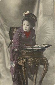 Hand Colored Postcard Japanese Woman in Kimono With Postcard Album Ornate Table