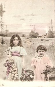 Two little girls carrying flowers from fields  Tuck France Un Mot a la Poste S