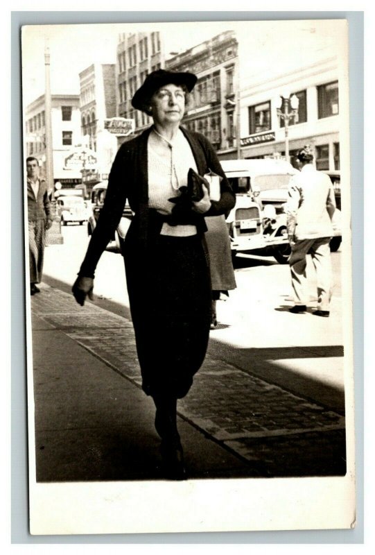 Vintage 1937 RPPC Postcard Woman Walking in the City Antique Cars in Distance 