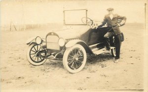 RPPC Postcard Man Stands Next To Early Automobile Paige? Emblem