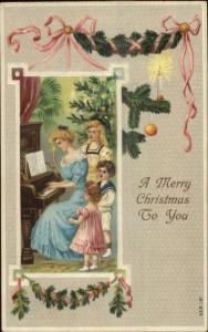 Christmas - Mother & Children at Piano Series 151 c1910 Embossed Postcard