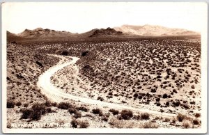 Nevada Desert Road Mountain Ranges Roadway Real Photo RPPC Postcard