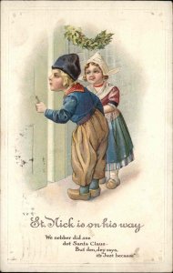 Christmas Dutch Children Peeking Look for Santa Embossed c1900s-20s Postcard