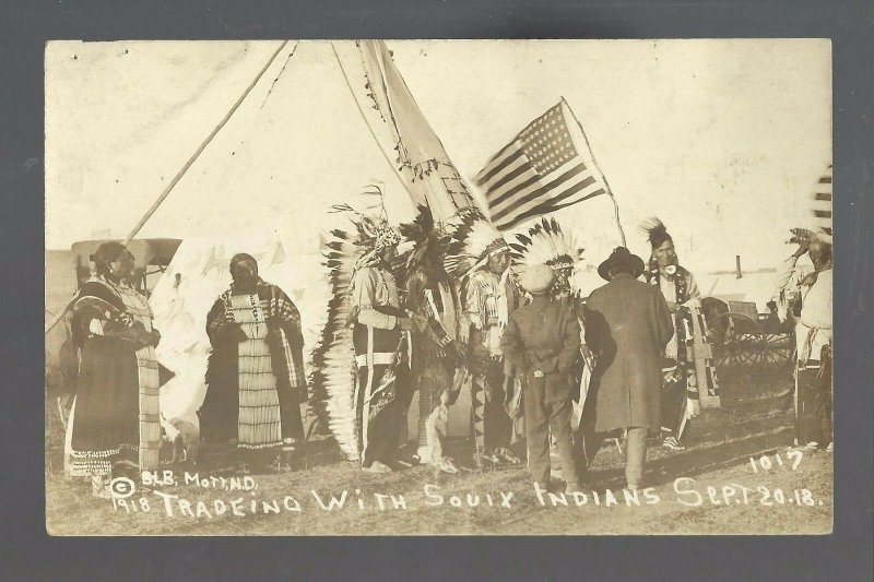 Mott NORTH DAKOTA RPPC 1918 SIOUX INDIANS Indian Trading WHITE MAN Trader FLAG 