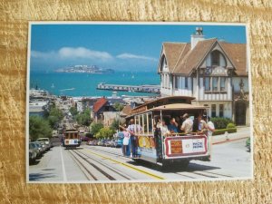 TWO CABLE CARS PASS STEEP HYDE ST HILL WITH ALCATRAZ IN BACKGROUND POSTC*P34