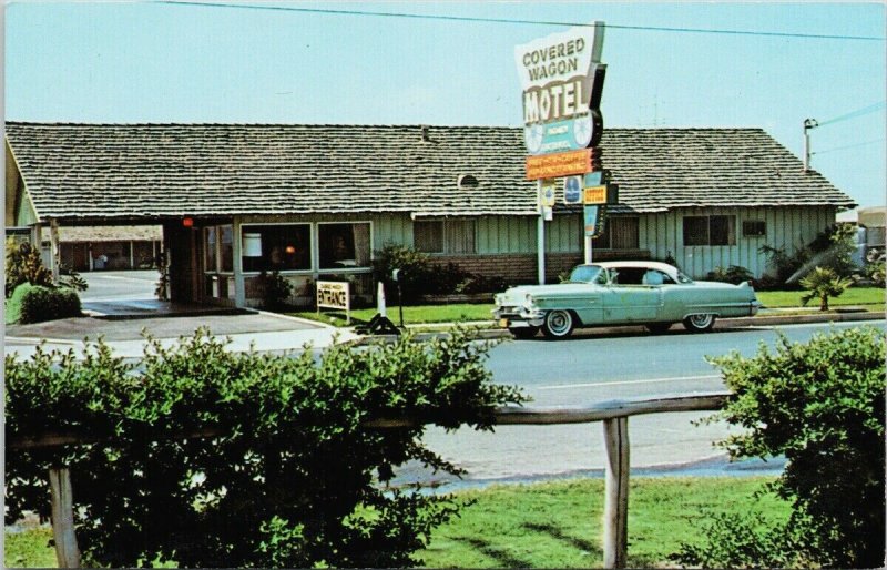 Buena Park CA Covered Wagon Motel Knott's Berry Farm Blue Car Postcard F68