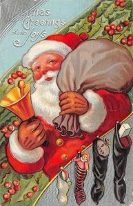 Holiday  CHRISTMAS GREETINGS & JOYS Red Santa Claus~Stockings~Bell 1909 Postcard