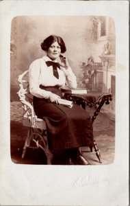 Real Photo Postcard Studio Portrait Woman Sitting with a Book