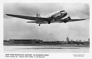 New York NY LaGuardia Plane Taking Off Empire State Building in Background RPPC