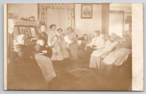 RPPC Family Gathered Piano In Parlor Grandmothers Women Children Postcard L27