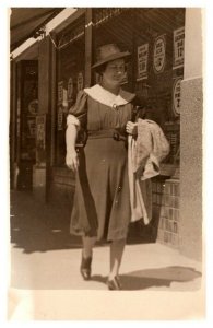 Woman in Hat Walking Down Street RPPC