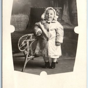 c1910s Cute Little Boy RPPC Winter Fur Coat Real Photo Wicker Chair Smile A129