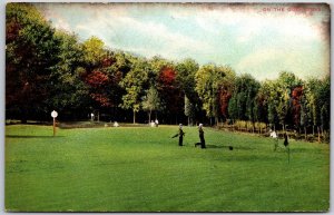 1907 Men Playing Golf Grounds & Evergreen Trees In Background Posted Postcard