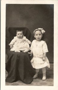 RPPC Cute Children White Dress & Shoes Hair Bow Baby on Chair Postcard U9