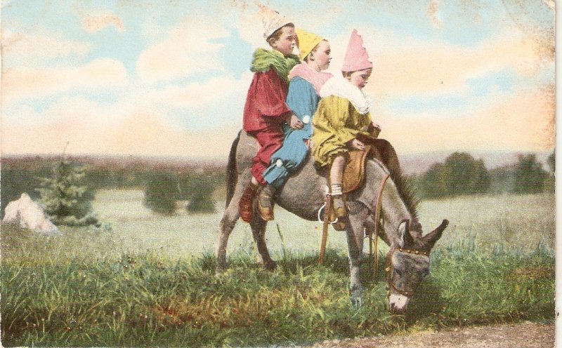 Clown children. Driving on donkey Old vintage English postcard
