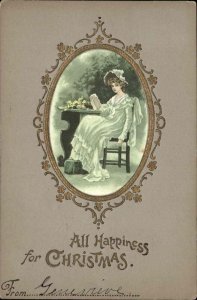 Christmas Pretty Woman Fancy Reading Book at Table Gilt Embossed c1900s-20s PC