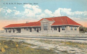 C. M. & ST. P. TRAIN DEPOT MILES CITY MONTANA POSTCARD (c. 1910)