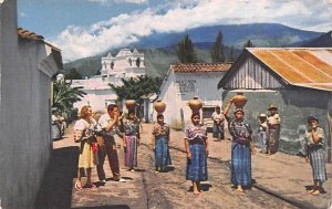 Guatemalan Women carrying water home in large earthen jugs Guatemala, Central...