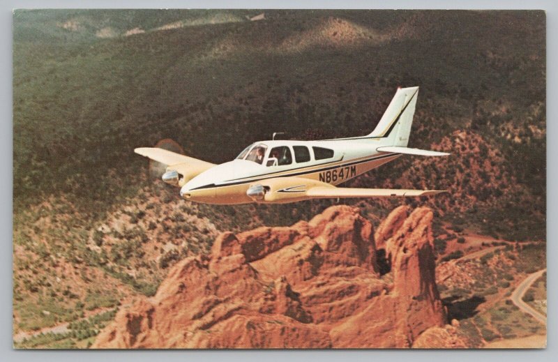 Aircraft~The Beechcraft B55 Baron Over Garden Of Gods Colorado~Vintage Postcard 