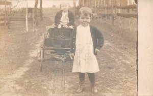 RPPC CHILDREN & WAGON TOY REAL PHOTO POSTCARD (c. 1910)