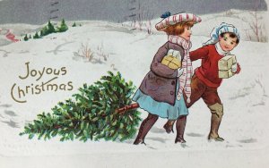 1912 Joyous Christmas Postcard Couple People Pulling Tree Through Snow