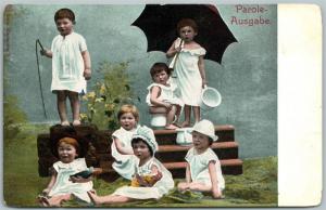 MULTIPLE BABIES w/ DOLLS & UMBRELLA ANTIQUE POSTCARD 