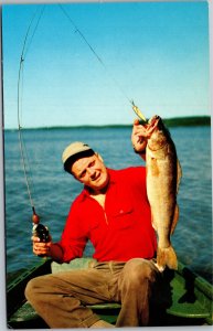 Postcard MN Fishing Man in boat holding up caught fish Minnesota lakes