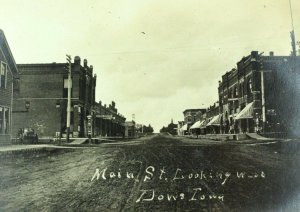 C 1905 RPPC Downtown Main St. Dows, Iowa Barber Shoes Signs Wagon Postcard F84