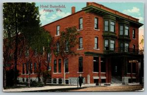 Antigo Wisconsin~Hotel Butterfield~Man Leans on Hitching Post~c1910 Postcard