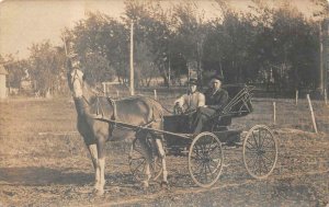 RPPC HORSE CARRIAGE AND MEN IDENTIFIED ON REVERSE REAL PHOTO POSTCARD (c. 1910)