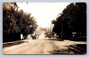 J90/ Hartford Wisconsin RPPC Postcard c1910 Main Street Stores Autos 130