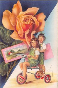 YOUNG CHILDREN ON TRICYCLE-LARGE FLOWER-ARTIST C VIVEL SPAIN POSTCARD