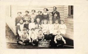 G32/ Nebraska RPPC Postcard 1913 School Building Students Teacher