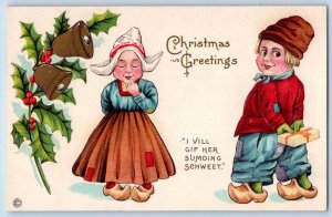 Christmas Postcard Greetings Dutch Kids Boy With Gift Holly Berries Bells c1910s